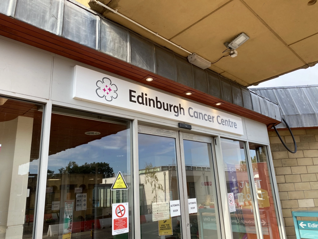 Edinburgh Cancer Centre sign tray mounted above the entrance doors