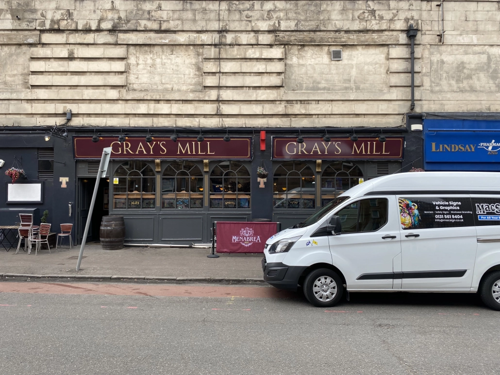 Gray's Mill bar frontage with dark fascia panels and gold cut lettering
