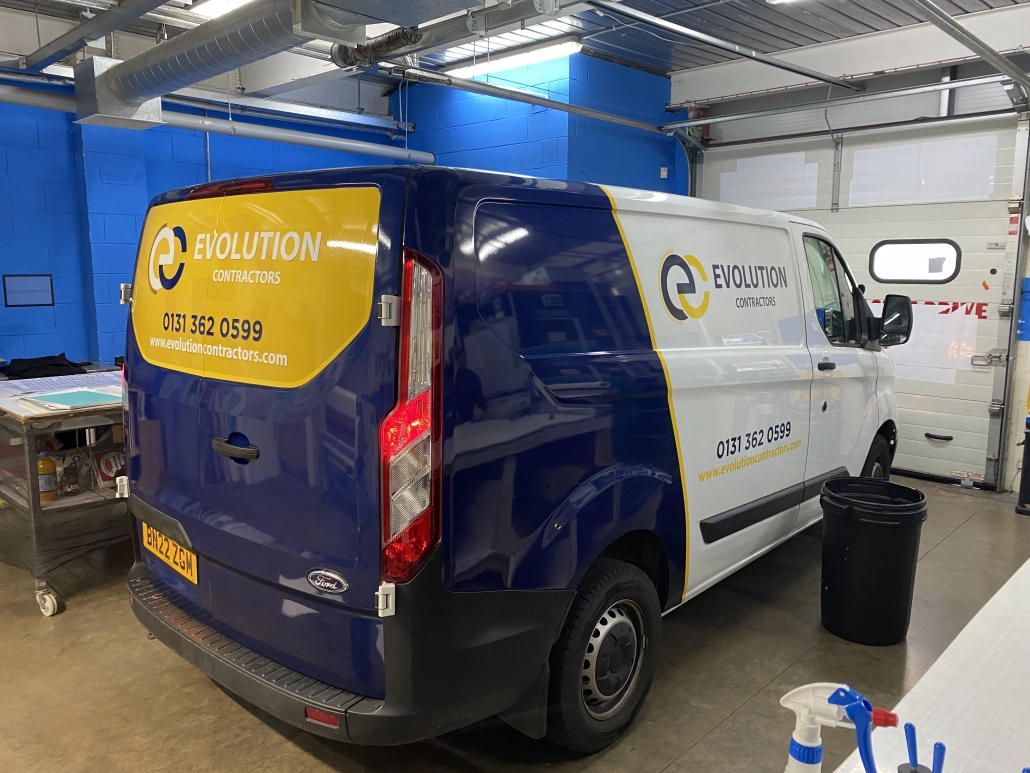 Evolution Contractors van in dark blue livery with yellow logo panel and contact details